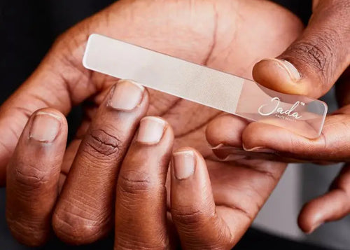 Man using the JADA Nano Glass Nail File to smoothly shape and seal natural nail edges.