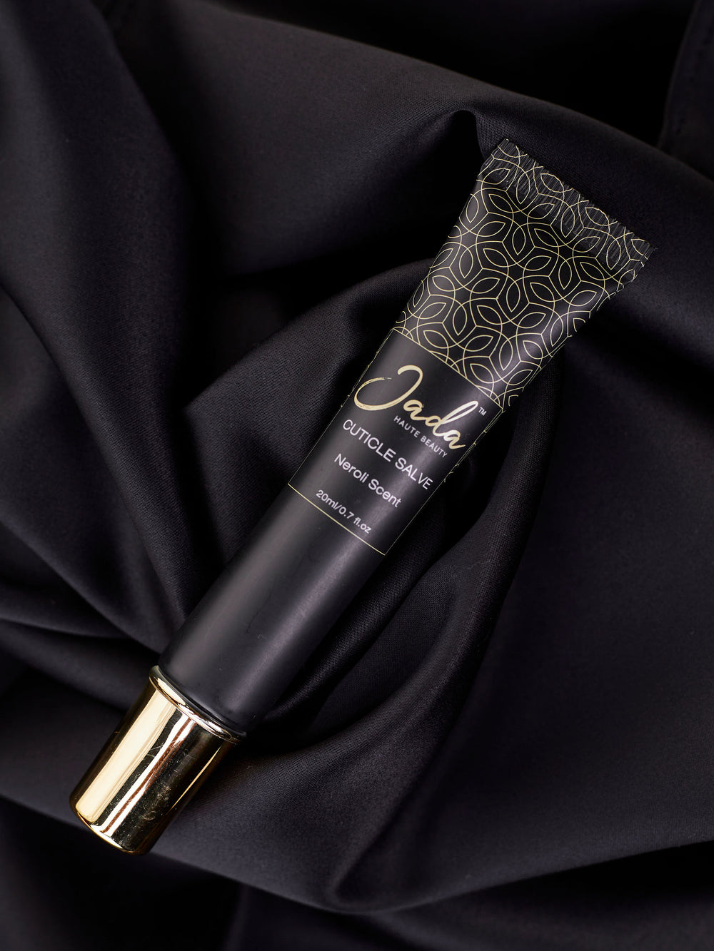 JADA Kenya natural nail care product bottle displayed on a sleek black surface.