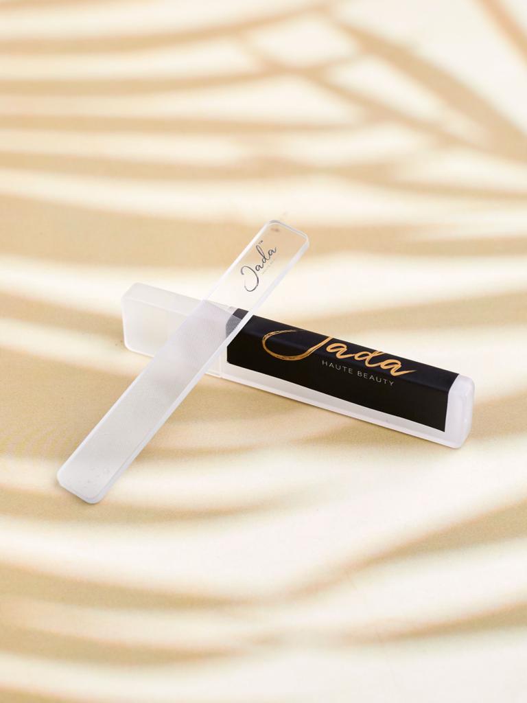 JADA Nano Glass Nail File positioned next to its white protective travel case.